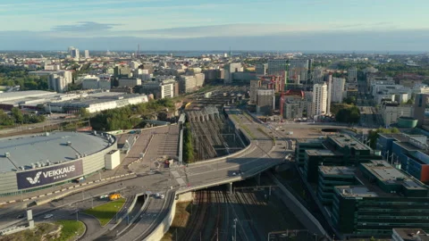 Drone following a train moving through Central Pasila, sunny evening in Helsinki Vídeo Stock 318633679