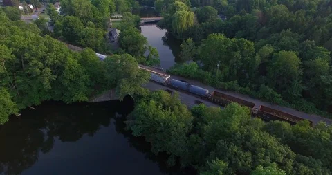 Drone - Following Train Through Small Town Stock Footage 128935422
