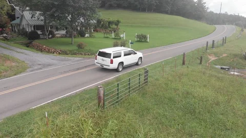 Drone Following a White SUV through a Rural Road. Stock Footage 94131627