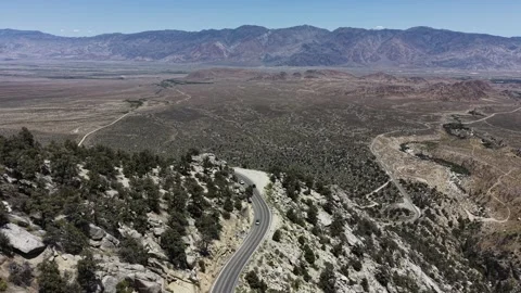 Drone Follows Dark Car Down Whitney Portal Road Curve Toward Owens Valley Vídeos de archivo 338164348