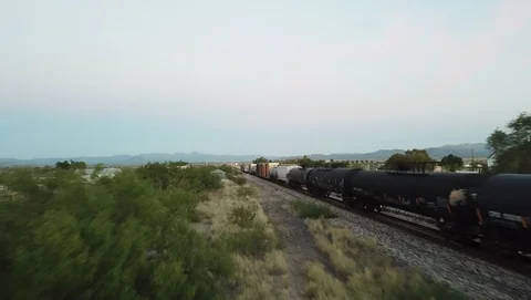 Drone follows freight train rolling past town in western Texas Stock-Footage 101081287