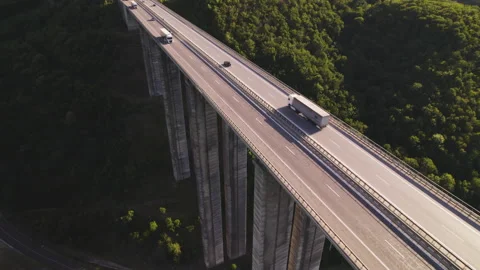 Drone follows loaded white semi-truck driving on Bebresh viaduct Stock Footage 160425342