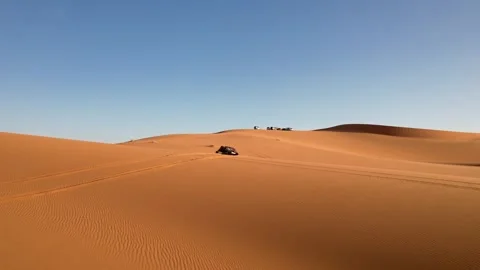 Drone follows side-by-side UTV driving across Erg Chebbi sand dunes near 스톡 동영상 339250752