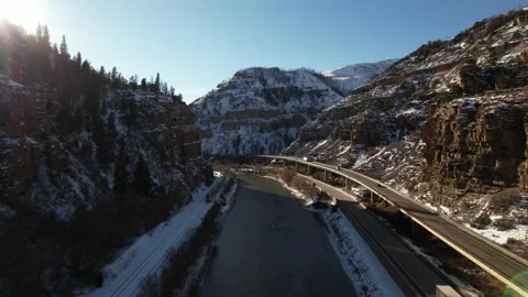 Drone follows Train through the Snowy Rocky Mountains in Colorado During Winter Stock Footage 296465423