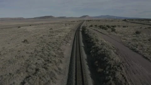 Drone follows train tracks in an open western field Vídeos de archivo 161811680