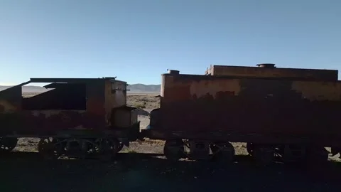 Drone footage of abandoned train graveyard in desert Stock Footage 314671624