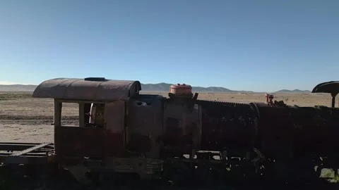 Drone footage of abandoned train graveyard in desert Stock Footage 314671722