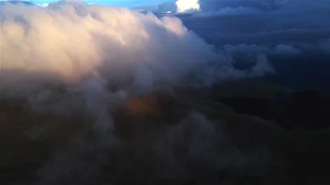 Drone footage above the clouds. Huge fluffy clouds at sunset in the highlands. Stock Footage 153644904