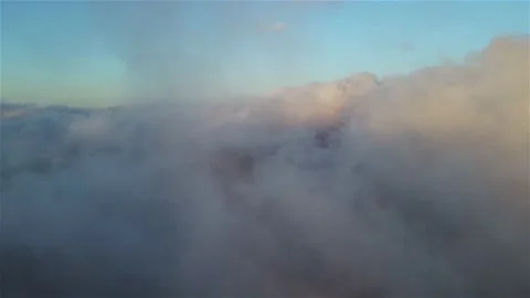 Drone footage above the clouds. Huge fluffy clouds at sunset in the highlands. Stock Footage 153644971