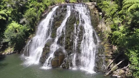 Drone footage approaching Owharoa Falls as multiple streams cascade over Stock Footage 341025267