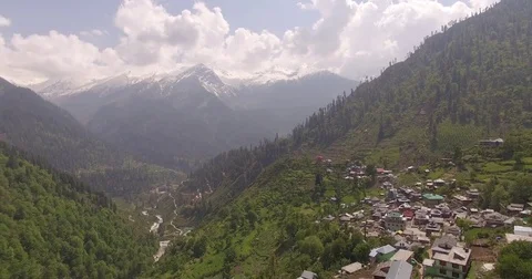 Drone footage backing up through mountain village Stock Footage 81003430