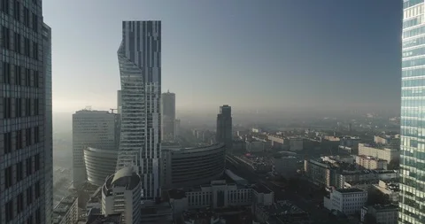 Drone footage of a backwards movement between skyscrapers and glass office bu Stock Footage 106893000