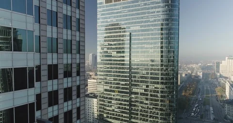 Drone footage of backwards movement next to glass office buildings in Warsaw Stock Footage 106463603