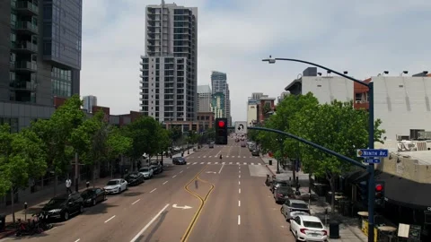 Drone footage beginning close to a traffic stoplight and pulling back to reveal Stock Footage 332096628