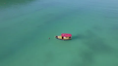 Drone footage of bird eye view of tracking docking boats, calm ocean Stock Footage 320669867