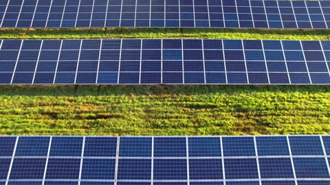 Drone footage of blue solar modules covering large renewable power site Stock Footage 346708433