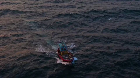 Drone footage of a boat navigating rough seas 4k video clip 動画素材 305156807