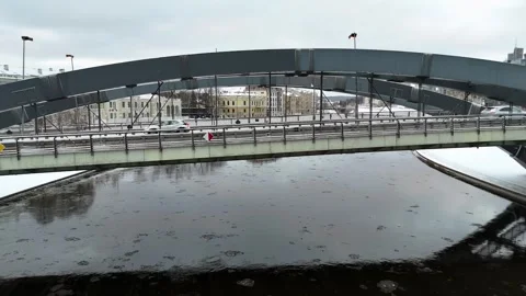 Drone footage of a bridge over a river in a city during winter day Stock Footage 272336630