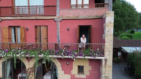 Drone footage, the camera flies up to a beautiful tourist in pajamas on the Stock Footage 282295947