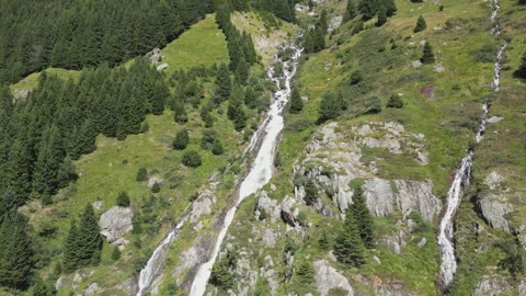 A drone footage of the camera quickly zooming in on a waterfall. Stock Footage 271608818