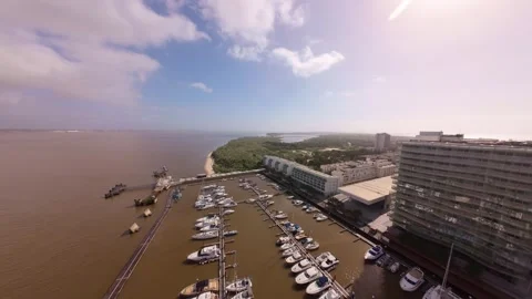 Drone footage captures beachside marina surrounded by high-rise hotels Stock Footage 345060233