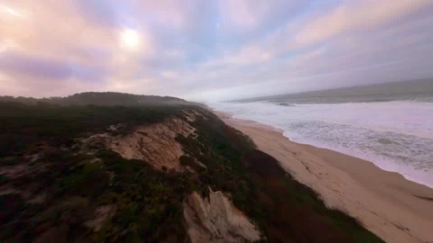 Drone footage captures dramatic coastal landscape during sunrise Stock Footage 345055153
