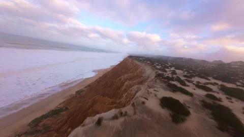 Drone footage captures dramatic coastline with textured cliffs Stock Footage 345055404