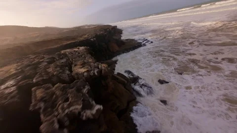 Drone footage captures dramatic waves crashing against rocky coastline Video stock 344678262