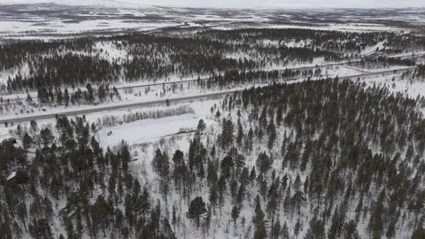 Drone footage captures the expansive snow covered landscapes, dense forests and Stock Footage 330376742