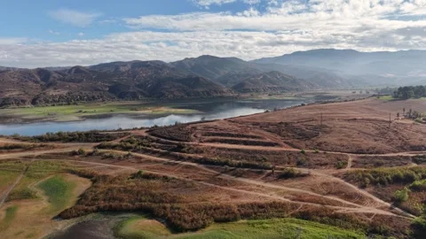 Drone footage captures a patchwork of dry brush, riverbeds, and open plains set Stock Footage 319463022