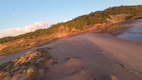 Drone footage captures serene beachfront at sunrise Stock Footage 344582981