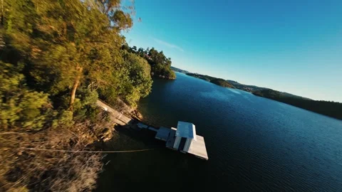 Drone footage captures tranquil lake landscape under clear blue sky Video stock 342271710