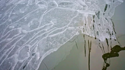 Drone footage capturing abstract ice formations across the frozen surface of Stock Footage 340236322