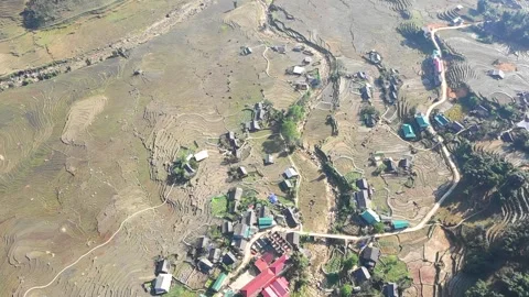 Drone footage capturing an aerial perspective of terraced rice fields and a Stock Footage 346664425