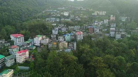 Drone footage capturing ascending multicolored buildings in Gangtok’s hilly Stock Footage 311369624