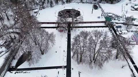 Drone footage capturing bare-branched trees framing the historic Verinag spring Stock Footage 311129493