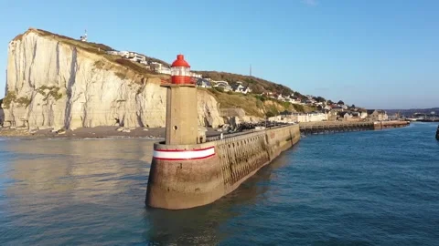 Drone footage capturing the iconic red and white lighthouse at the entrance of Stock Footage 346674063