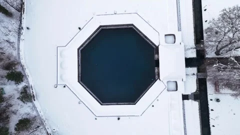 Drone footage capturing the peaceful isolation of Verinag spring from a wide Stock Footage 311129195