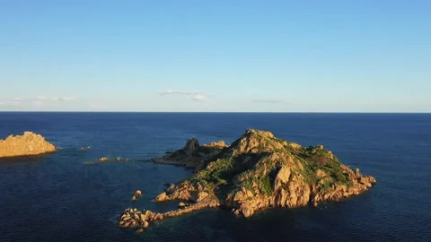 Drone footage capturing the rocky, green Isola dellOgliastra surrounded by the Stock Footage 346671103