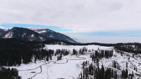 Drone footage capturing scenic roads in Dhoodhpathri’s white landscape. Stock Footage 311793697