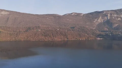 Drone footage capturing a wide view of Lake Aiguebelette in Savoie, France, with Stock Footage 346709736