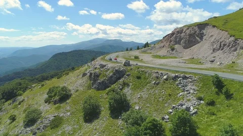 Drone footage of car passing another car on mountain road in Bulgaria Stock Footage 111945475
