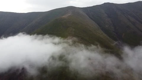 Drone footage of cloud inversion over mountain landscape Stock Footage 338104838