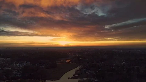 Drone footage of clouds moving towards sunrise on a somewhat cloudy sunrise. Stock Footage 122604522