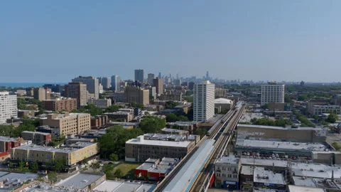 Drone footage of CTA elevated tracks leading toward the Chicago skyline, past Stock Footage 346384792