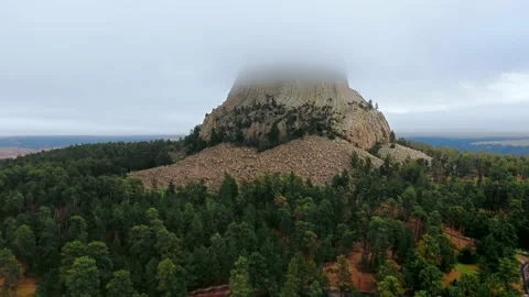 Drone footage of Devil's Tower rock surrounded by a dense forest in Wyoming, USA Video stock 138114817