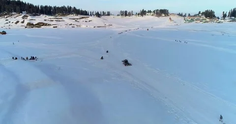 Drone footage of dramatic snowfall blanketing and cleaning process by machines Stock Footage 310657561