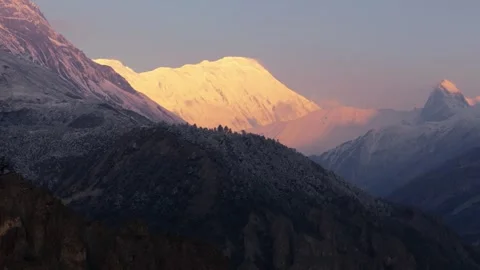 Drone footage of the first rays of sunrise casting a warm glow on the pristine Stock Footage 311019118