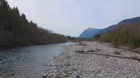Drone footage of a fly over of an Alpine Valley and Forest in the Spring Stock Footage 74076532