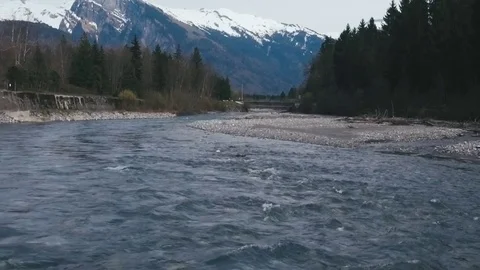 Drone footage of a fly over of an Alpine Valley and Forest in the Spring Stock Footage 74076576